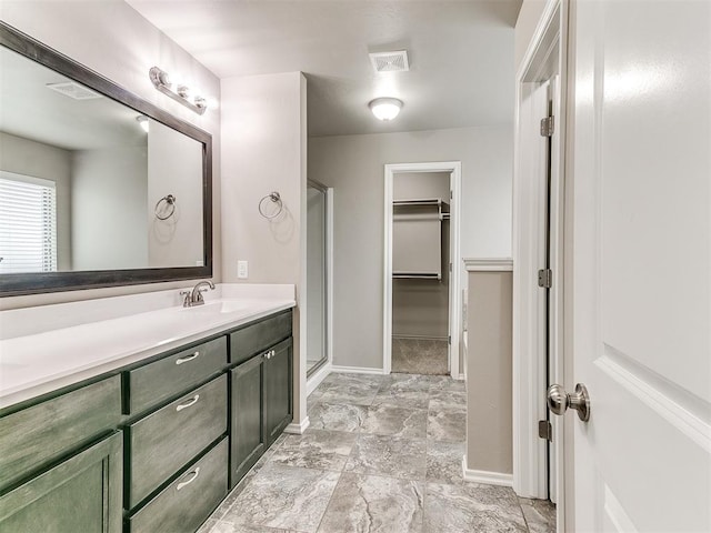 bathroom featuring vanity and an enclosed shower