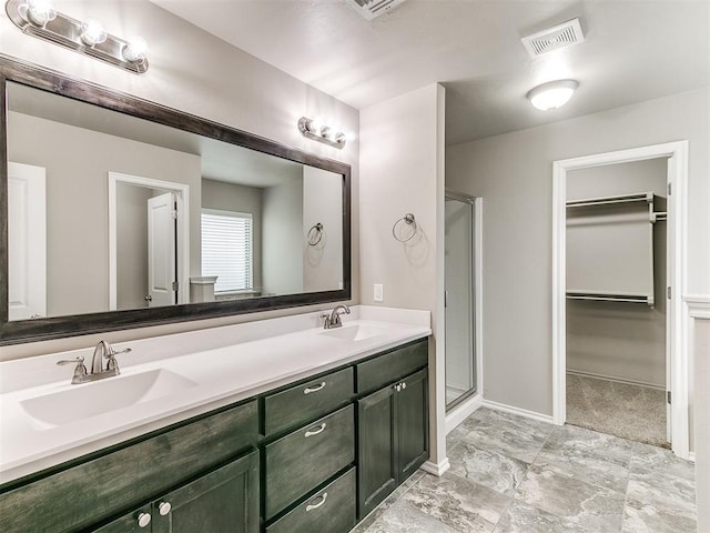 bathroom featuring vanity and a shower with shower door