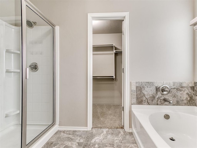 bathroom featuring separate shower and tub