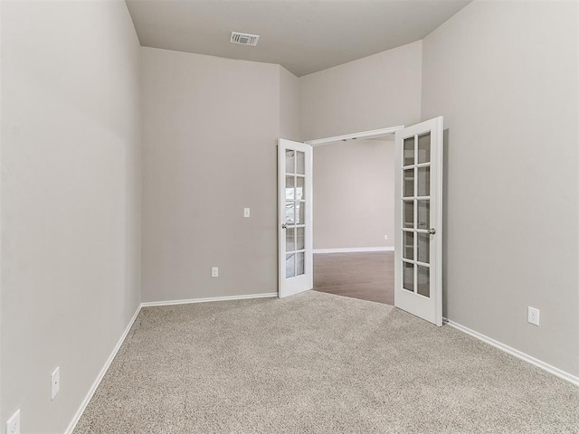 spare room with french doors and carpet floors