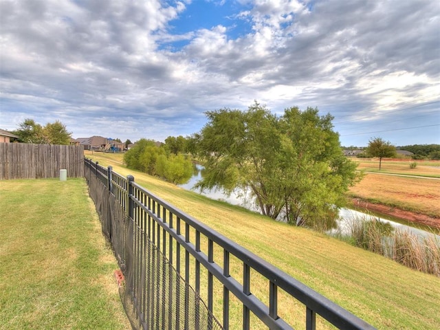 exterior space featuring a lawn and a water view