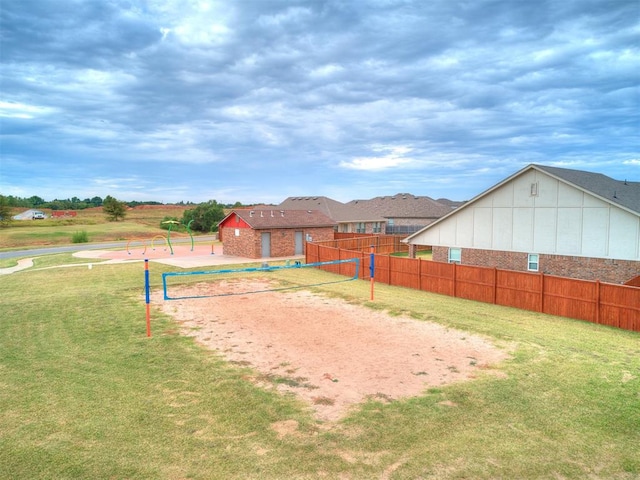 view of home's community with volleyball court and a lawn