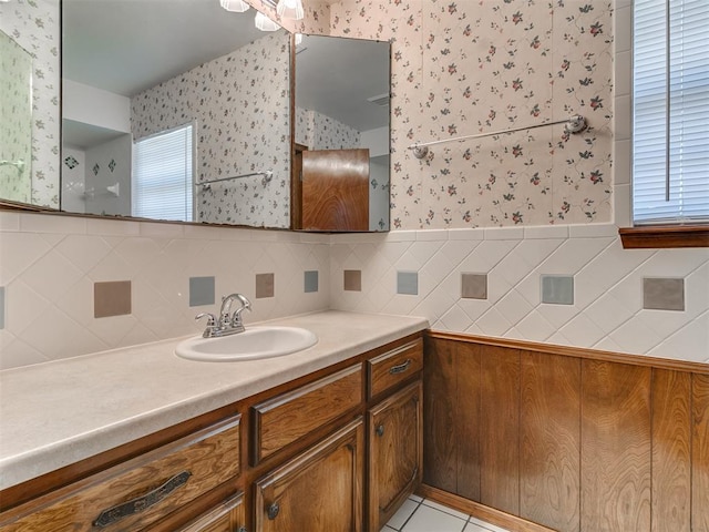 bathroom featuring tile patterned floors, vanity, and backsplash