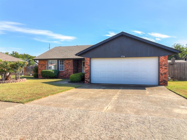 single story home featuring a garage and a front lawn