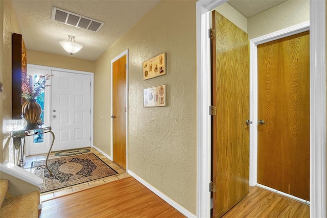 interior space with wood-type flooring and a textured ceiling