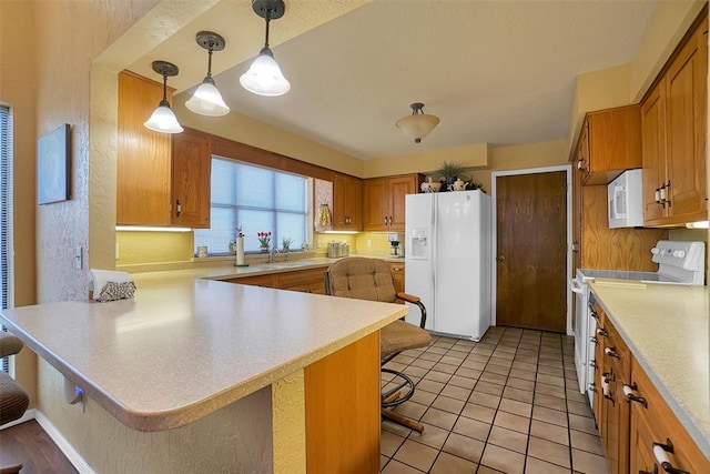 kitchen with kitchen peninsula, pendant lighting, white appliances, a breakfast bar area, and light tile patterned floors