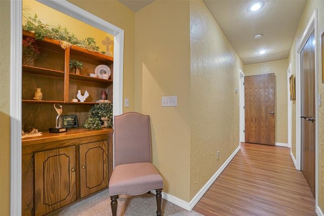 corridor with light hardwood / wood-style flooring