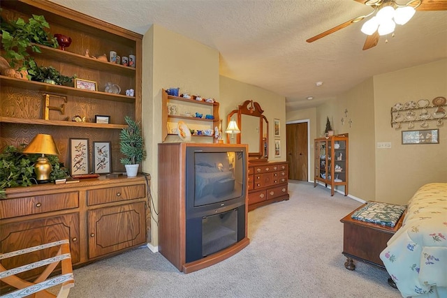 living room featuring light carpet, a textured ceiling, and ceiling fan