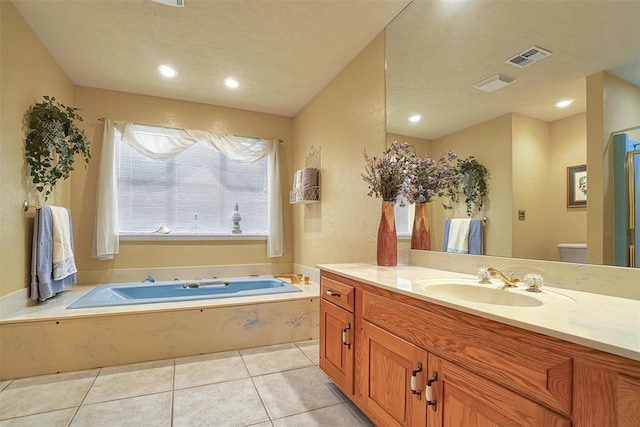 bathroom featuring tile patterned floors, a tub to relax in, and vanity