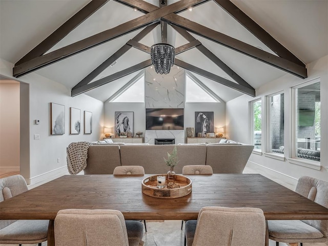 dining room featuring lofted ceiling with beams