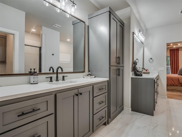 bathroom with vanity and a shower with door