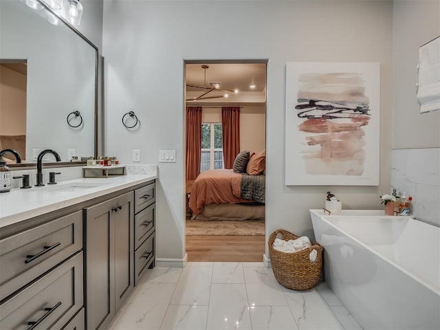 bathroom with a bathtub, vanity, and hardwood / wood-style floors