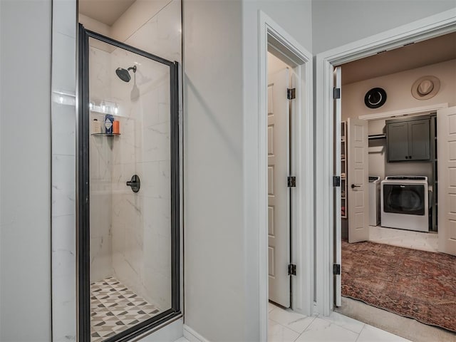 bathroom with an enclosed shower and washing machine and clothes dryer