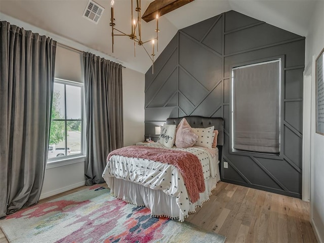 bedroom with vaulted ceiling with beams, light hardwood / wood-style floors, and a notable chandelier