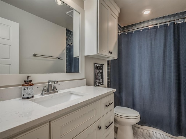 bathroom with vanity, toilet, and walk in shower