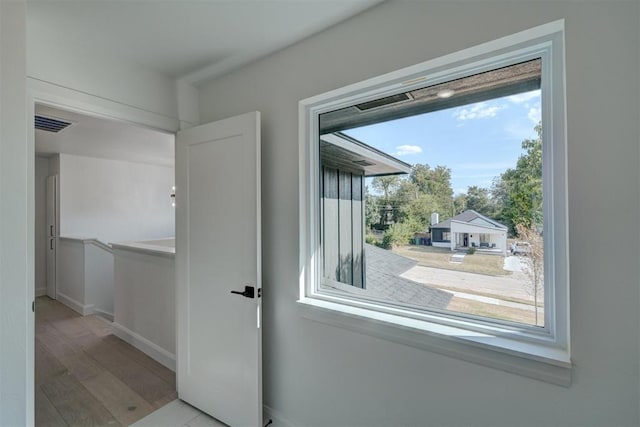 entryway featuring light wood finished floors, baseboards, and visible vents