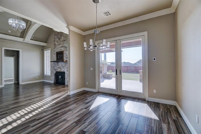 interior space featuring a notable chandelier, dark hardwood / wood-style flooring, and a fireplace