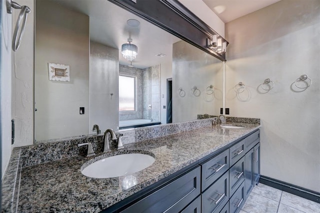 bathroom with tile patterned floors, vanity, and a washtub