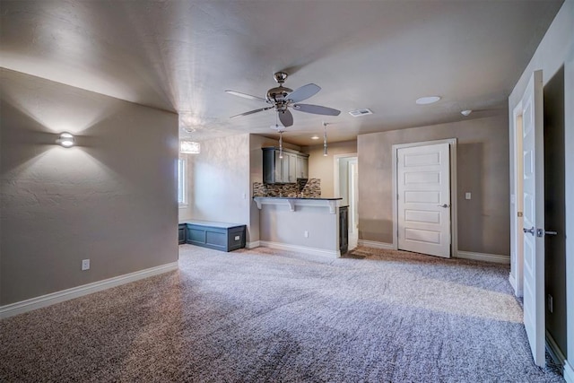 unfurnished living room featuring carpet and ceiling fan