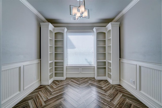 unfurnished dining area with a chandelier, parquet floors, and crown molding