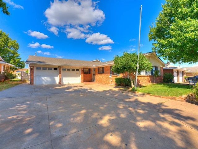 ranch-style home with a front yard and a garage