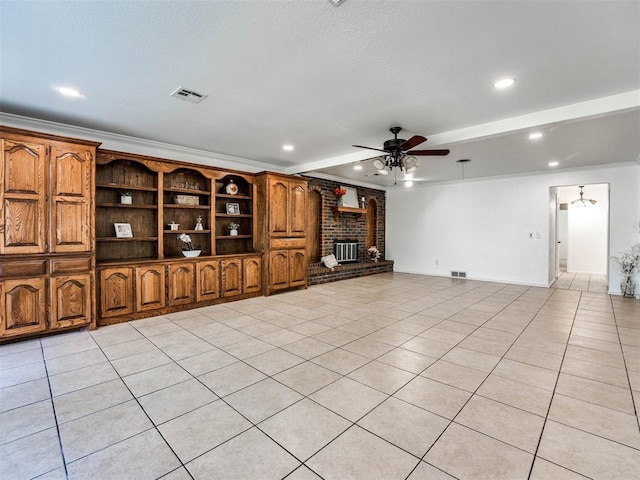 unfurnished living room featuring ceiling fan, a fireplace, light tile patterned flooring, and crown molding