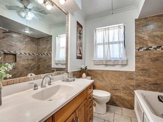 full bathroom with ceiling fan, crown molding, toilet, vanity, and tile walls