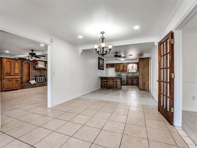 interior space featuring a fireplace, ceiling fan with notable chandelier, and crown molding