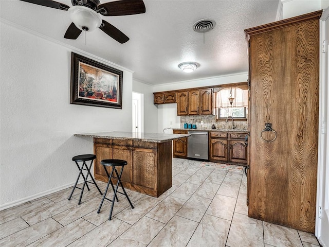 kitchen with kitchen peninsula, a kitchen bar, backsplash, stainless steel dishwasher, and sink