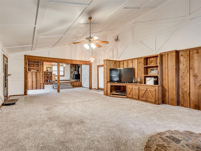 unfurnished living room with carpet flooring, ceiling fan, and vaulted ceiling