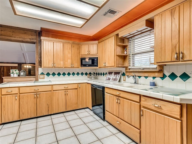 kitchen featuring tile counters, sink, tasteful backsplash, light tile patterned floors, and black appliances