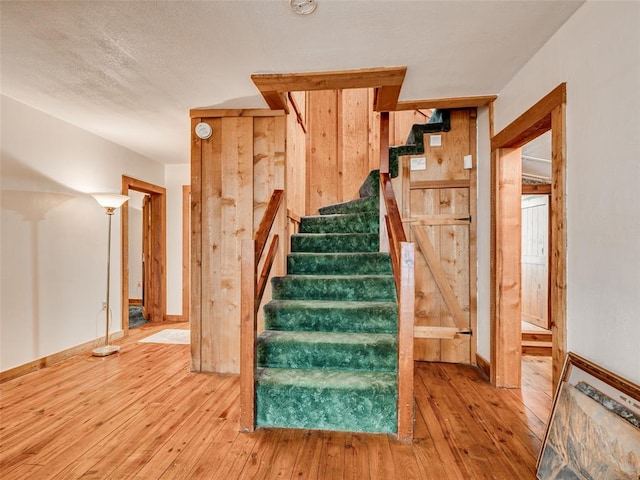 stairs featuring hardwood / wood-style floors