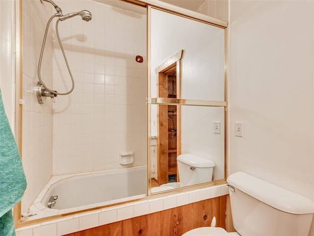 bathroom featuring toilet and tiled shower / bath