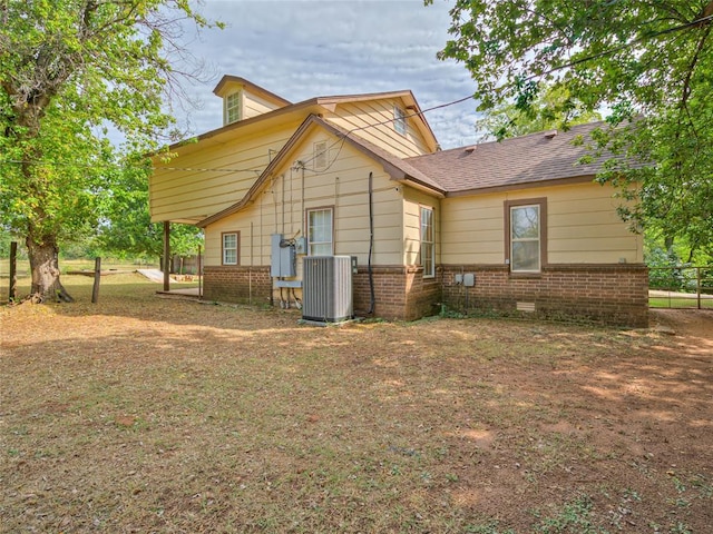 rear view of house featuring central AC unit