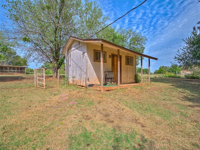 view of outbuilding with a lawn