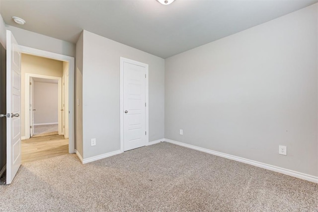 unfurnished bedroom featuring carpet floors and a closet