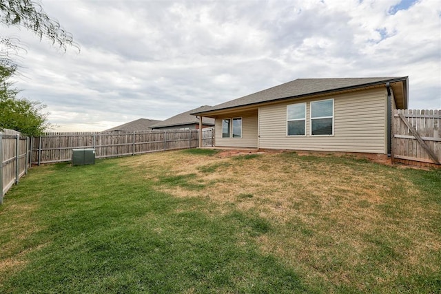 rear view of house featuring a lawn