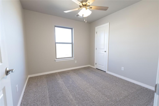 carpeted spare room with ceiling fan