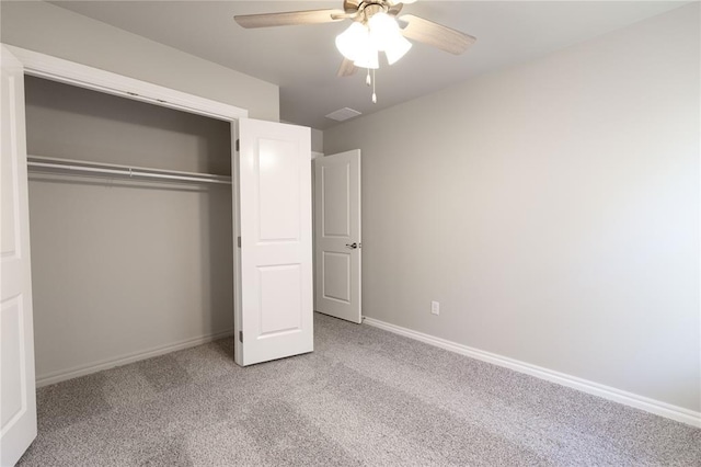 unfurnished bedroom with light carpet, ceiling fan, and a closet