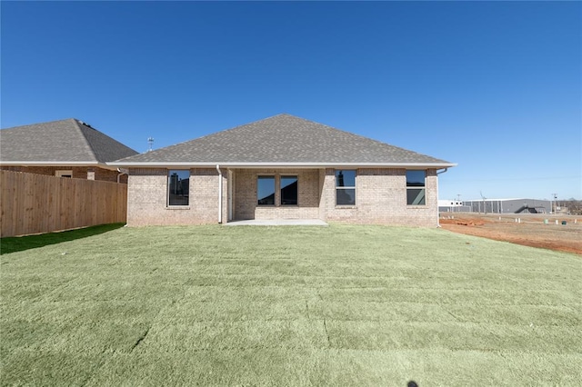 rear view of property with a patio and a lawn