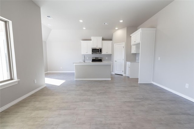 unfurnished living room featuring sink