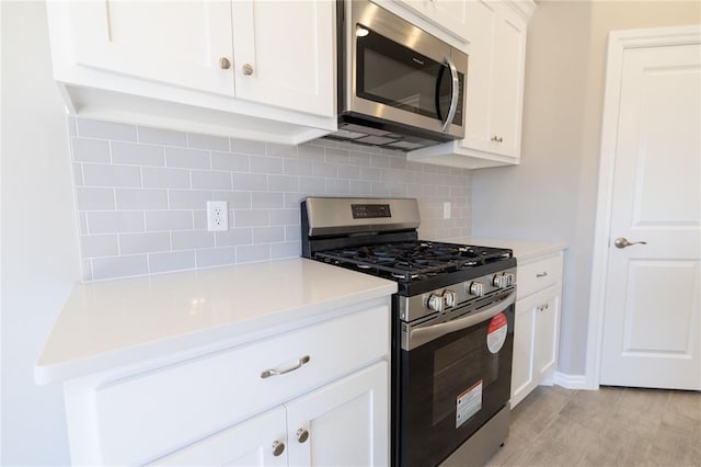 kitchen featuring white cabinetry, tasteful backsplash, and appliances with stainless steel finishes