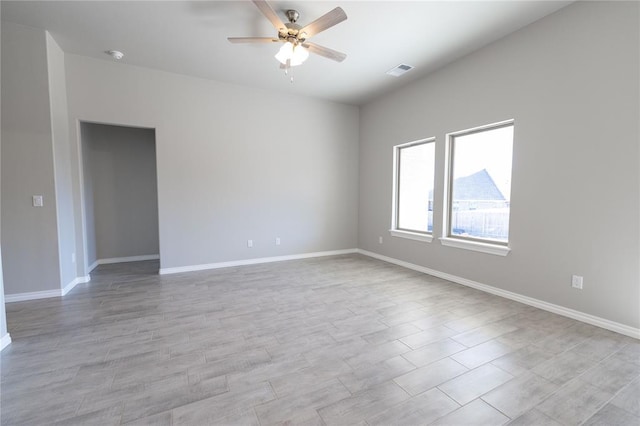 empty room featuring ceiling fan and light wood-type flooring