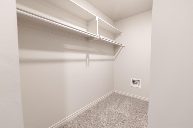 walk in closet with carpet