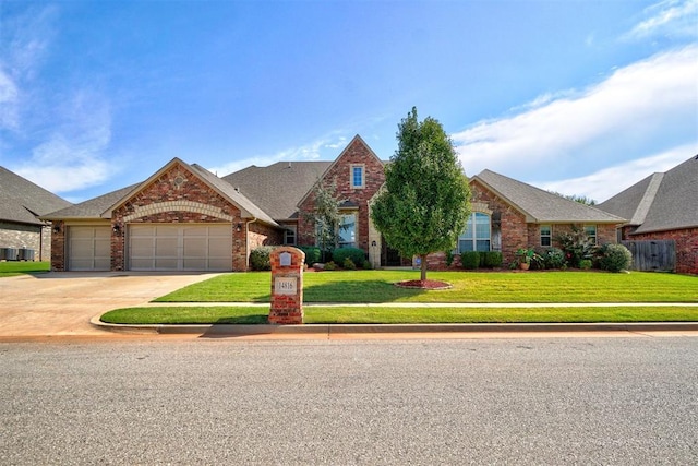 view of front of property featuring a garage and a front lawn