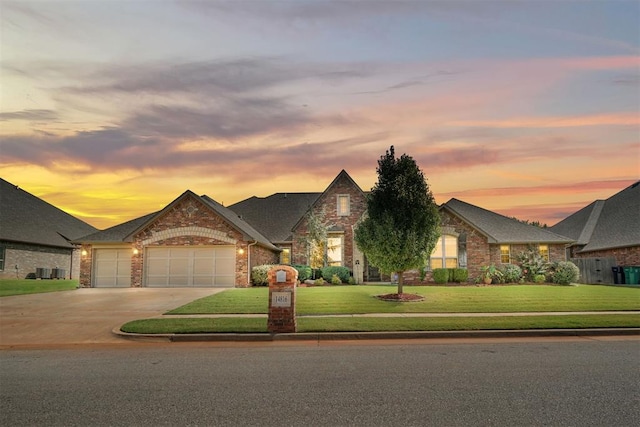 view of front of house with a garage and a lawn