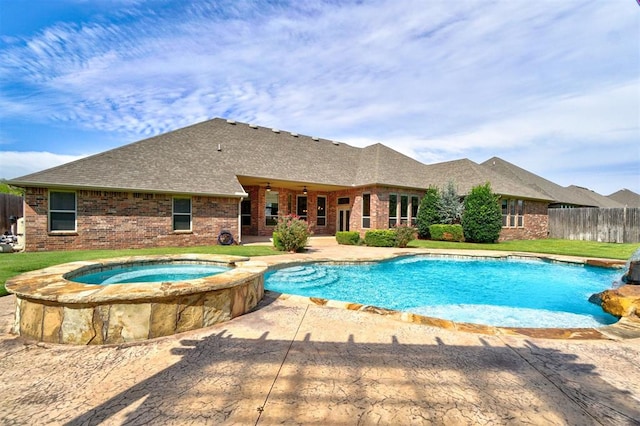 view of swimming pool with an in ground hot tub, a patio area, and a lawn