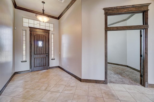 foyer entrance with baseboards, crown molding, and light tile patterned flooring