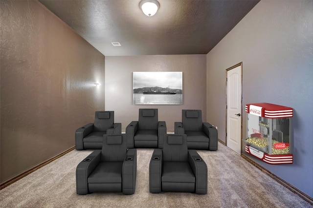 cinema room featuring carpet, baseboards, and a textured wall