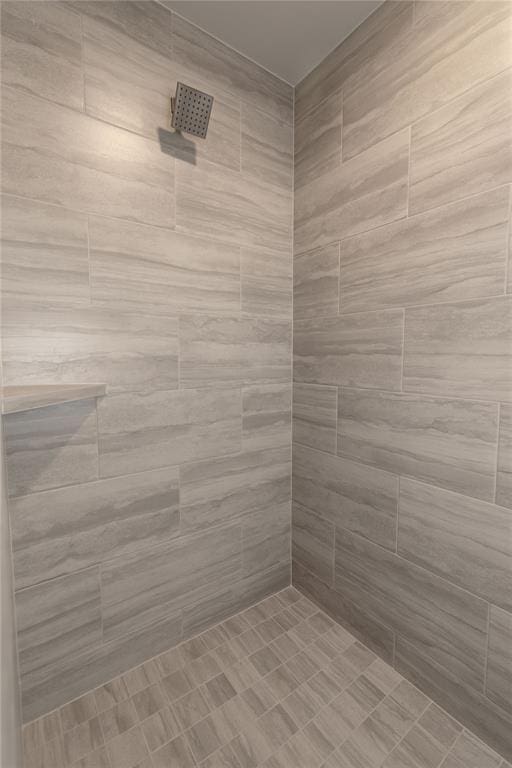 bathroom with a tile shower